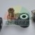 Magnetventilspule DC 24V mit DIN-Stecker und Kabelverschraubung auf grauem Hintergrund.